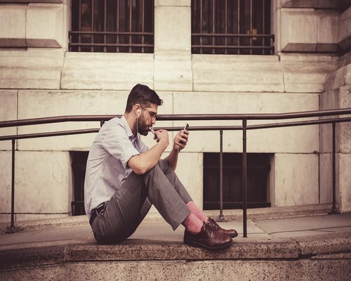 Person holding a smartphone with clear legible text while commuting